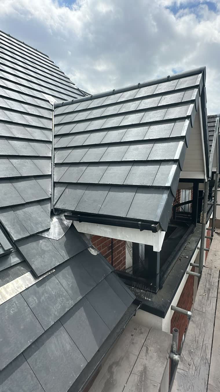 Slate roof with new lead work dressed around a dormer