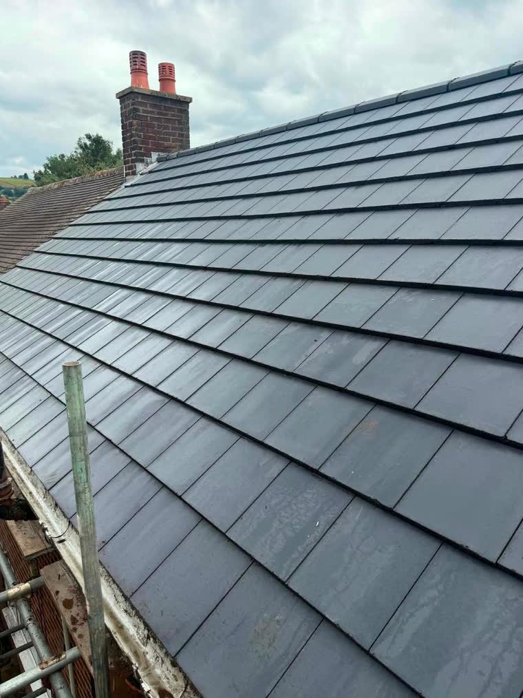 New slate roof covering laid across a full elevation in the North West
