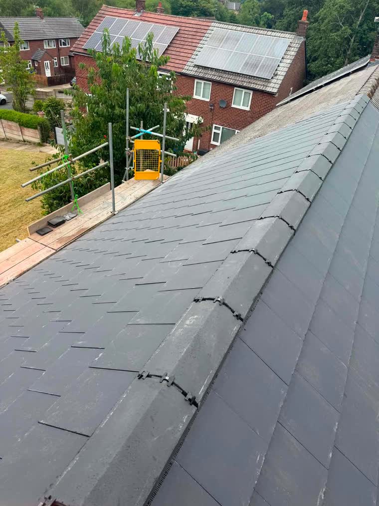 Completed slate roof finished with a dry ridge system